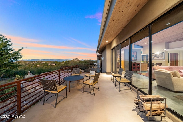 patio terrace at dusk featuring an outdoor hangout area