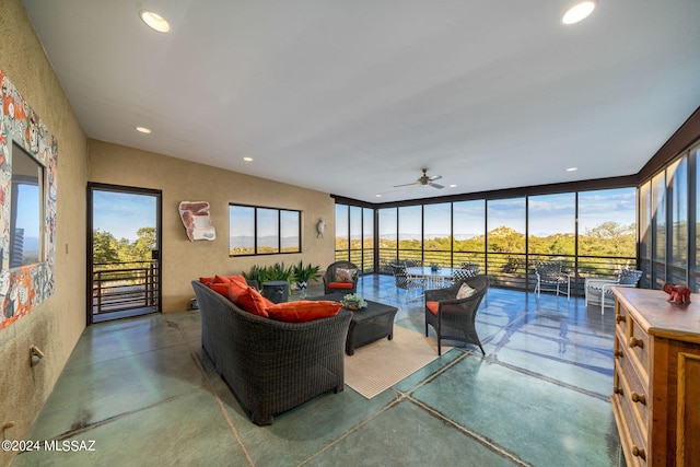 living room featuring concrete flooring and ceiling fan