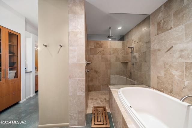 bathroom featuring shower with separate bathtub