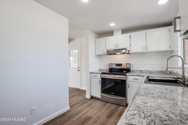 kitchen featuring white cabinets, sink, dark wood-type flooring, electric stove, and decorative backsplash