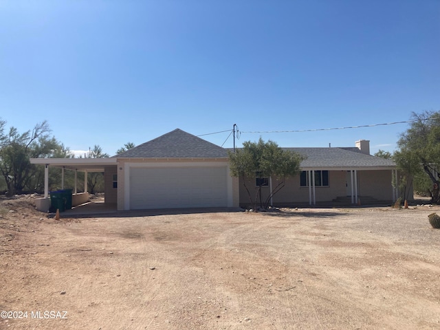 view of front of property with a carport and a garage