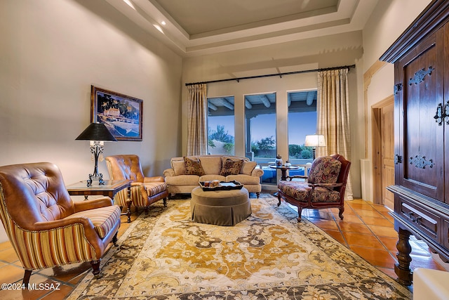 living room with a raised ceiling, a towering ceiling, and light tile patterned floors