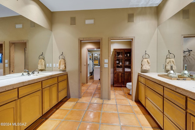 bathroom with tile patterned flooring, vanity, and toilet