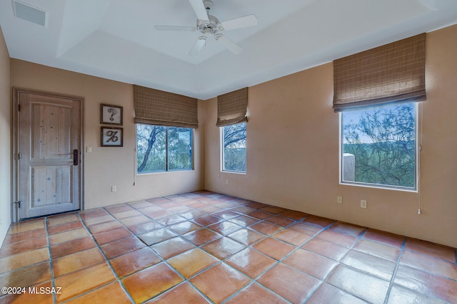 tiled spare room with ceiling fan