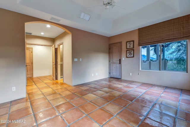 spare room featuring ceiling fan and light tile patterned floors