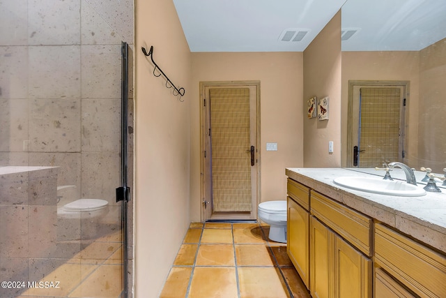 bathroom with walk in shower, vanity, toilet, and tile patterned floors