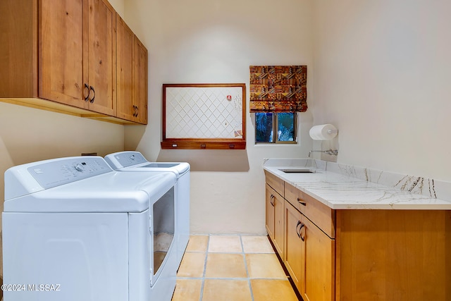 clothes washing area featuring cabinets, sink, independent washer and dryer, and light tile patterned flooring