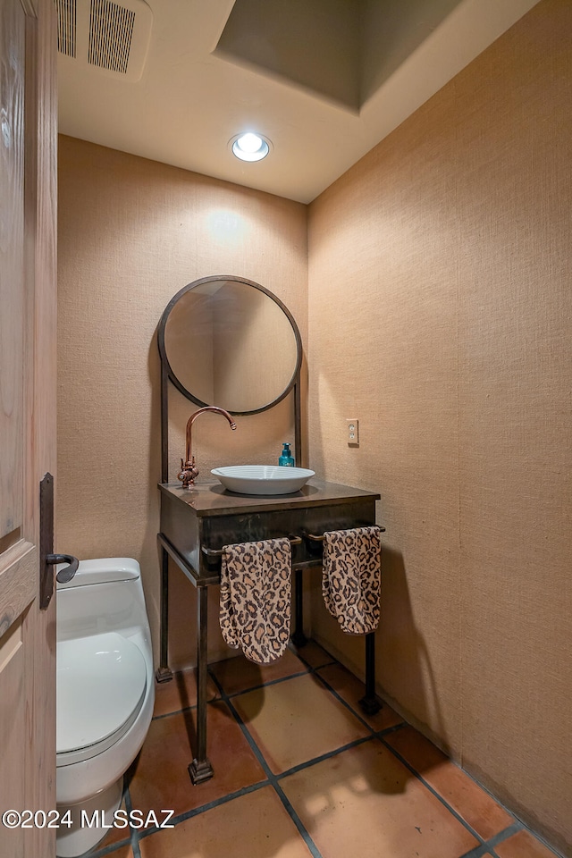 bathroom with sink, toilet, and tile patterned floors