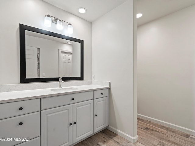 bathroom featuring hardwood / wood-style floors and vanity