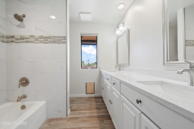 bathroom featuring vanity, hardwood / wood-style flooring, and tiled shower / bath