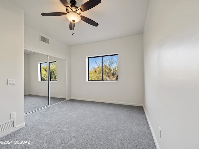 unfurnished bedroom with carpet flooring, a closet, and ceiling fan