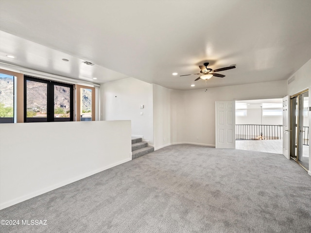 carpeted spare room with ceiling fan