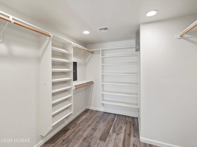 spacious closet with wood-type flooring and electric panel