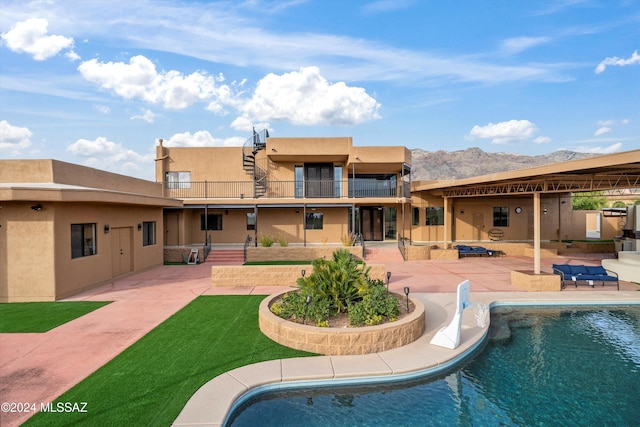 view of pool featuring a mountain view and a patio area