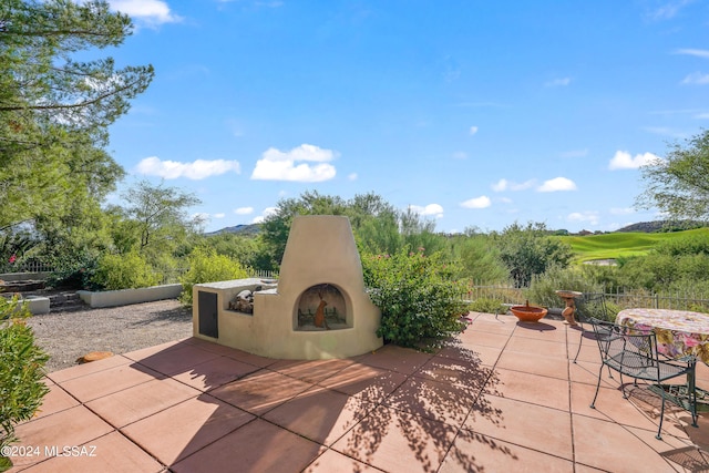 875 S Deer Meadow Loop, Tucson, AZ 85745 - view of patio / terrace with an outdoor fireplace