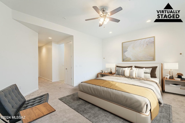 bedroom with ceiling fan and light carpet