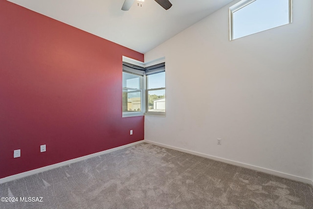 unfurnished room featuring ceiling fan, carpet, and vaulted ceiling