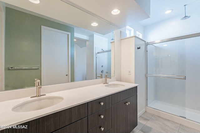 bathroom with vanity, tile patterned floors, and a shower with door