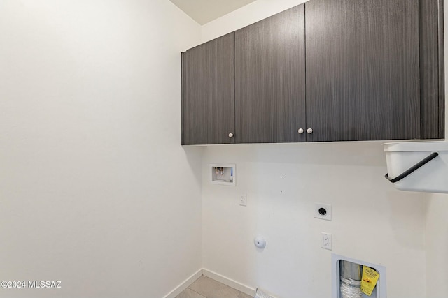 washroom with cabinets, washer hookup, electric dryer hookup, light tile patterned floors, and hookup for a gas dryer