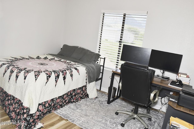 bedroom featuring wood finished floors and baseboards