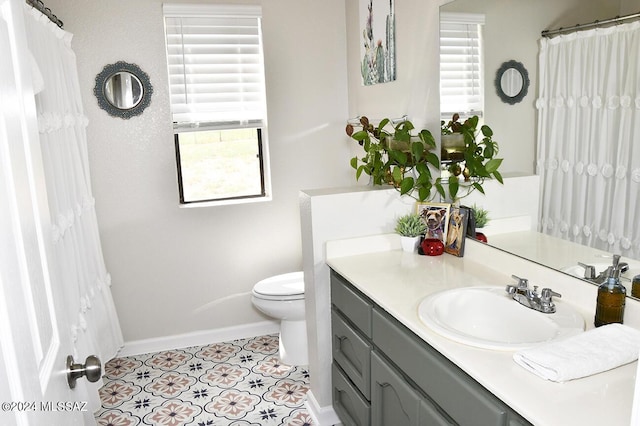 full bathroom with tile patterned floors, baseboards, toilet, and vanity