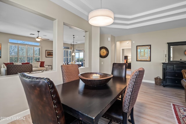 dining space with light wood-type flooring and ceiling fan