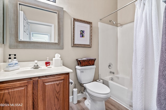 full bathroom with hardwood / wood-style floors, vanity, toilet, and shower / bath combo with shower curtain