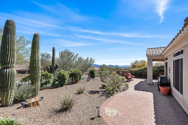 view of yard with a mountain view and a patio area