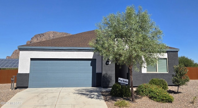 view of front of house featuring a mountain view and a garage