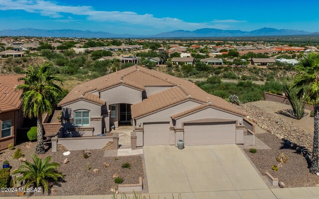 mediterranean / spanish-style home with a garage