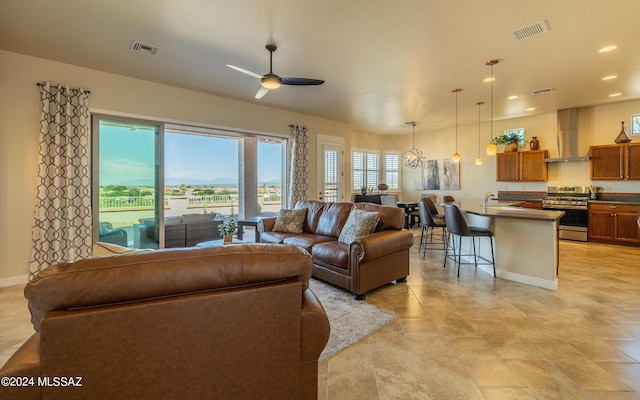 living room with ceiling fan and sink