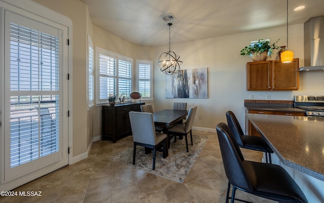 tiled dining space with a chandelier