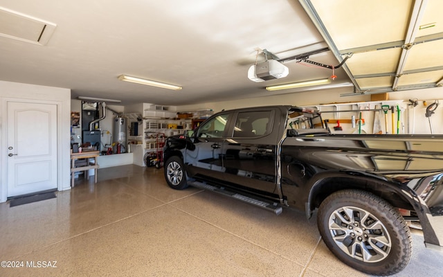 garage with a garage door opener and water heater