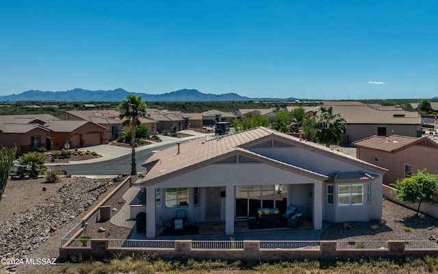 rear view of house featuring a mountain view, a patio, and central AC unit