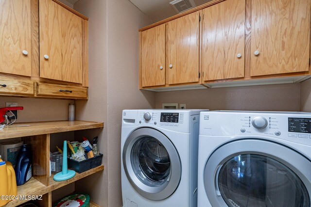 laundry room featuring cabinet space and washer and clothes dryer