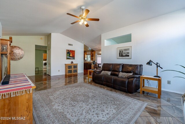 living room with ceiling fan, lofted ceiling, and a healthy amount of sunlight