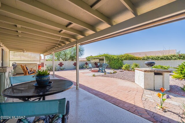 view of patio / terrace with a fire pit and a fenced backyard