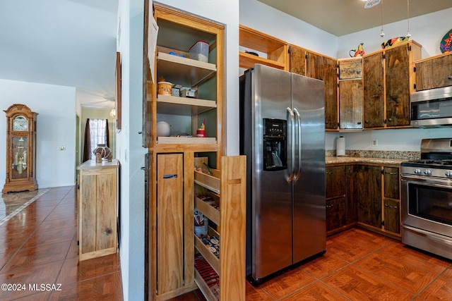 kitchen with light stone countertops and stainless steel appliances