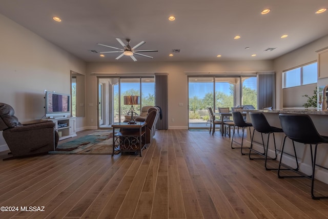 dining space featuring baseboards, visible vents, wood finished floors, and a ceiling fan