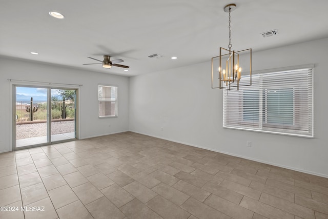 empty room with baseboards, ceiling fan with notable chandelier, visible vents, and recessed lighting