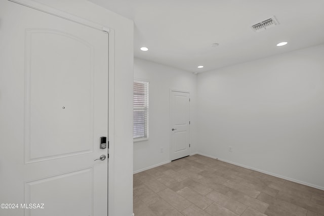 spare room with recessed lighting, baseboards, and visible vents