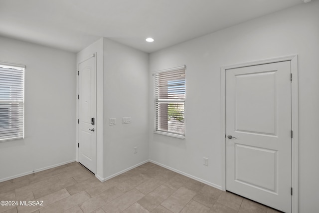 spare room with baseboards and recessed lighting