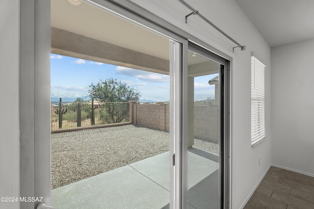 entryway with plenty of natural light and baseboards