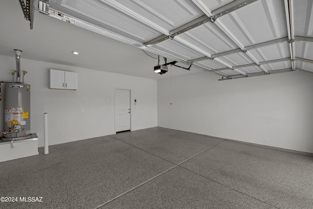 garage with a garage door opener and gas water heater