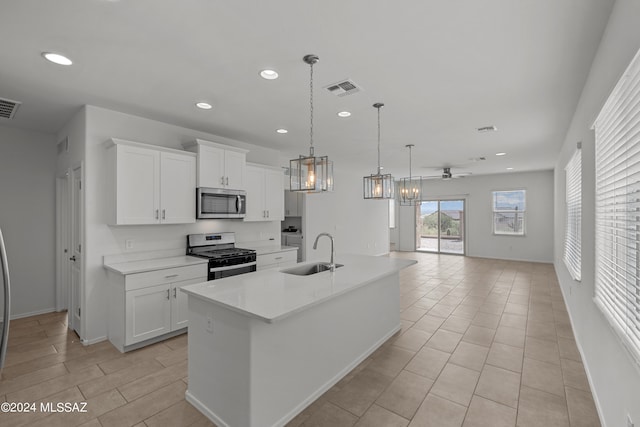 kitchen featuring stainless steel appliances, recessed lighting, visible vents, white cabinets, and a sink