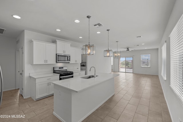 kitchen featuring a sink, visible vents, appliances with stainless steel finishes, and white cabinetry