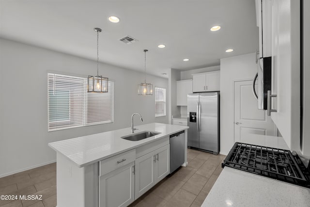 kitchen with white cabinetry, decorative light fixtures, stainless steel appliances, a sink, and visible vents