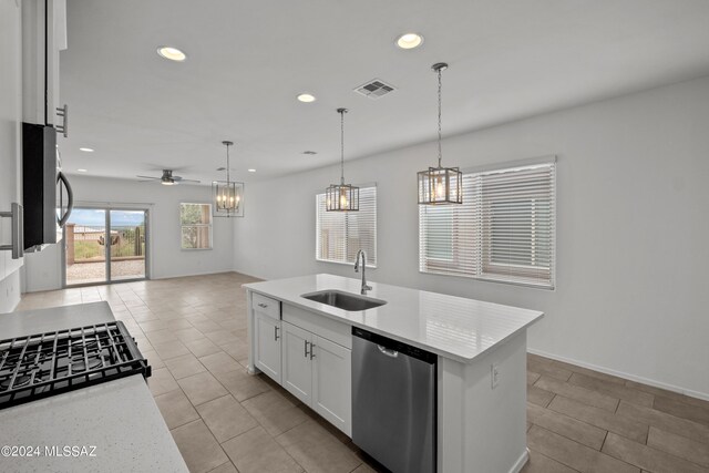 kitchen featuring ceiling fan, white cabinets, an island with sink, sink, and appliances with stainless steel finishes