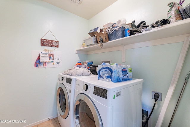 laundry area with light tile patterned flooring and separate washer and dryer