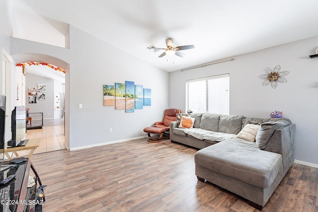 living room with lofted ceiling, hardwood / wood-style floors, and ceiling fan